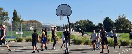 A group of people playing basketball

Description automatically generated