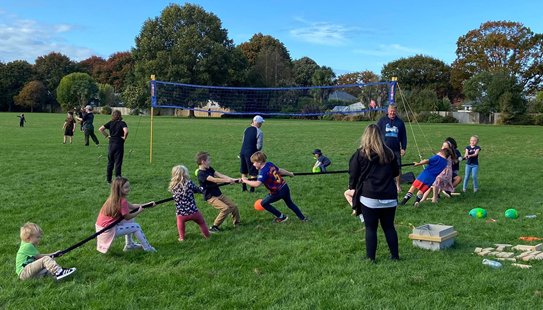 A group of kids playing in a field
Description automatically generated with low confidence