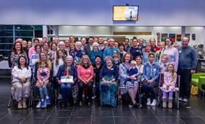 A group of people posing for a photo

Description automatically generated