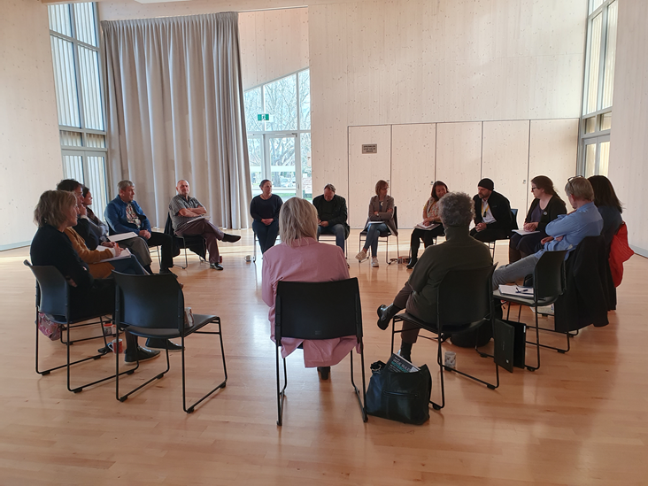 A group of people sitting in chairs

Description automatically generated