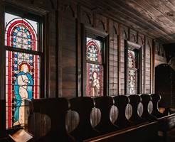 A row of stained glass windows in a church

Description automatically generated