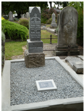 A tombstone in a cemetery

Description automatically generated