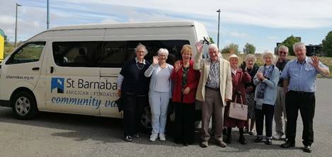 A group of people standing next to a white van

Description automatically generated with medium confidence