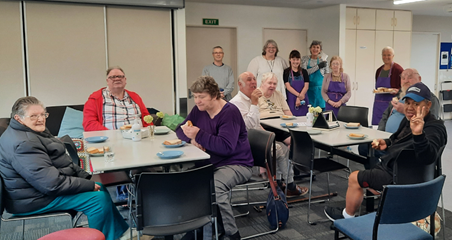 A group of people sitting at tables eating

Description automatically generated with medium confidence