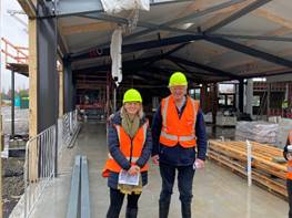 A person and person wearing safety vests and helmets

Description automatically generated with low confidence