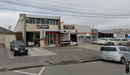 A parking lot with cars parked in front of it

Description automatically generated