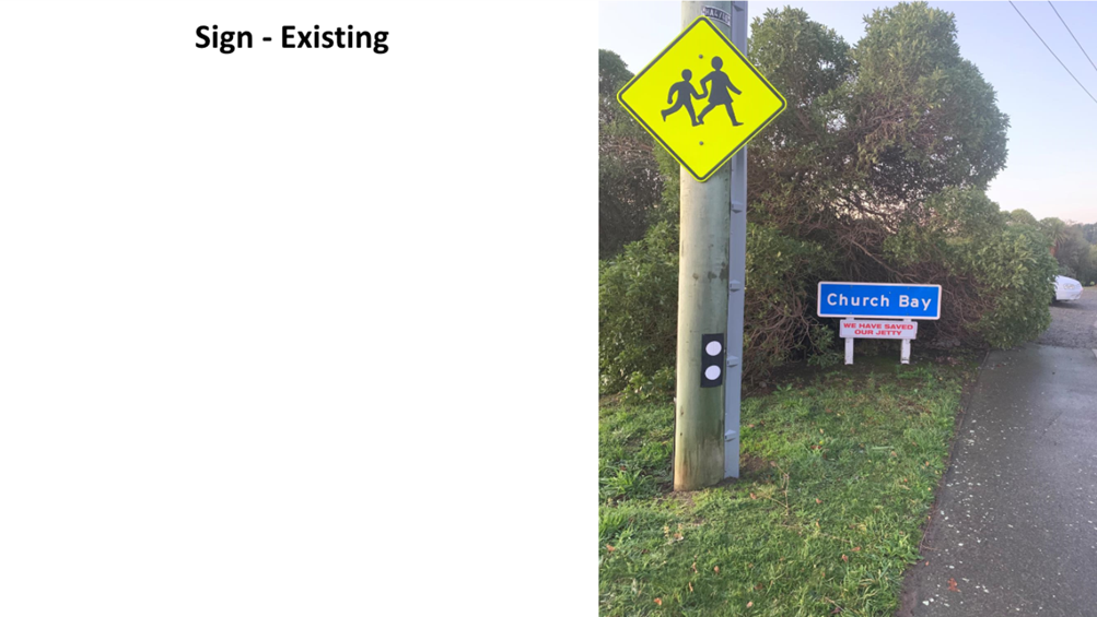 A sign post with a yellow sign and a yellow sign on it

Description automatically generated