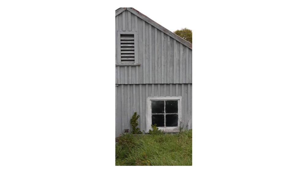 A grey house with a window

Description automatically generated