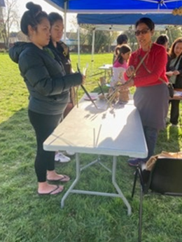 A group of people standing next to a table

Description automatically generated