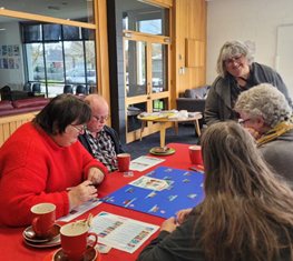 A group of people sitting around a table

Description automatically generated