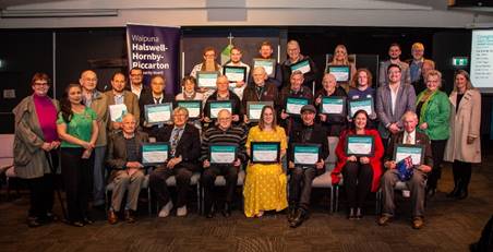 A group of people holding certificates

Description automatically generated