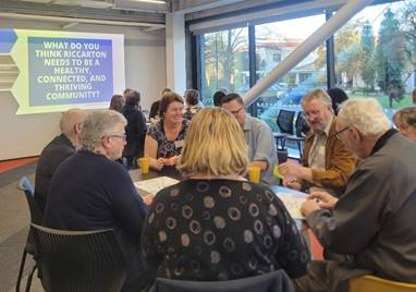 A group of people sitting around a table

Description automatically generated