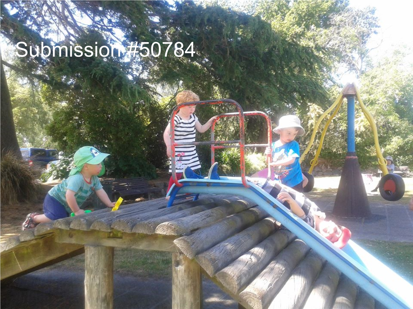 A group of kids playing on a playground

Description automatically generated