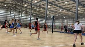 A netball game in motion at Christchurch Netball Centre.
