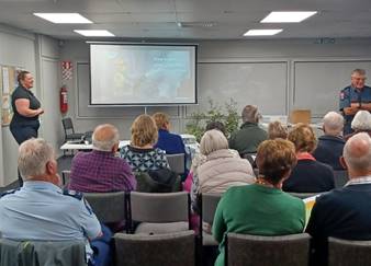 A group of people sitting together at the Getting prepared for the fire season presentation.

