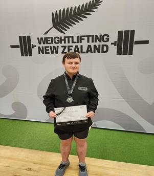 A person holding a medal

Description automatically generated