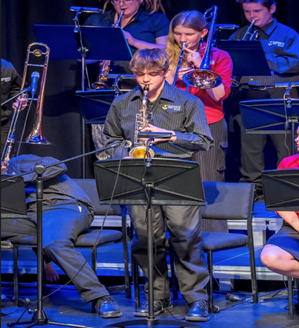 A group of people playing instruments

Description automatically generated