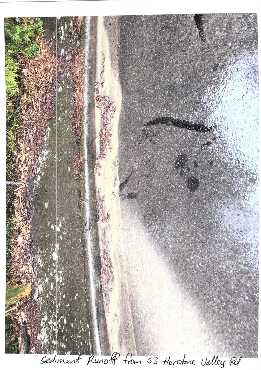 A wet road with a puddle of water

Description automatically generated with medium confidence