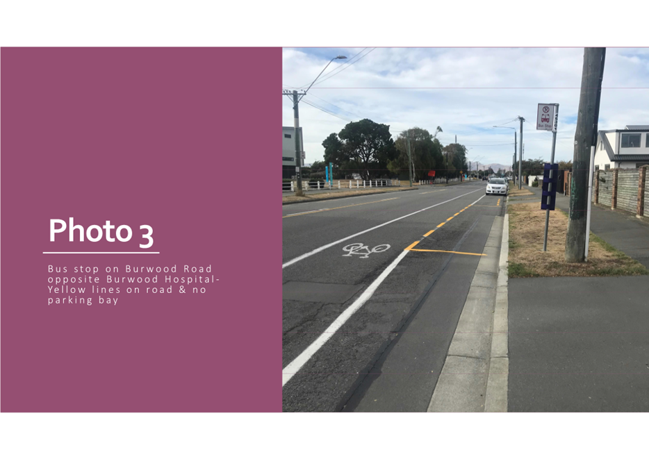 A road with a bike lane and a sign

Description automatically generated