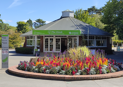 A building with a circular flower bed in front of it

Description automatically generated