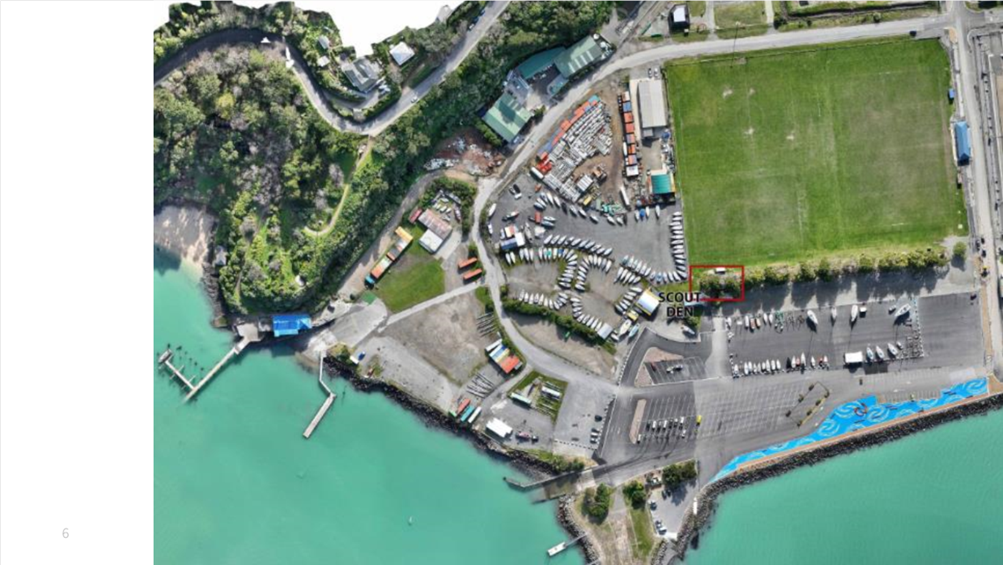 Aerial view of a parking lot and a body of water

Description automatically generated