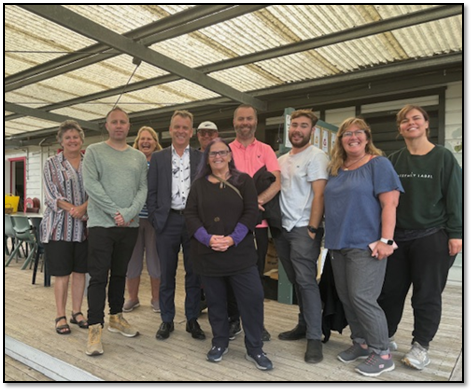 A group of people posing for a photo

Description automatically generated