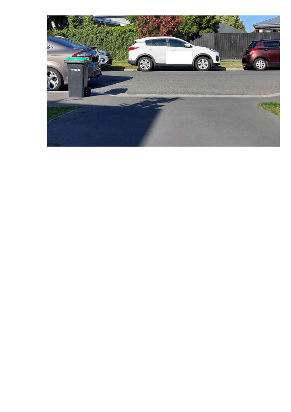 A white van parked in a parking lot

Description automatically generated