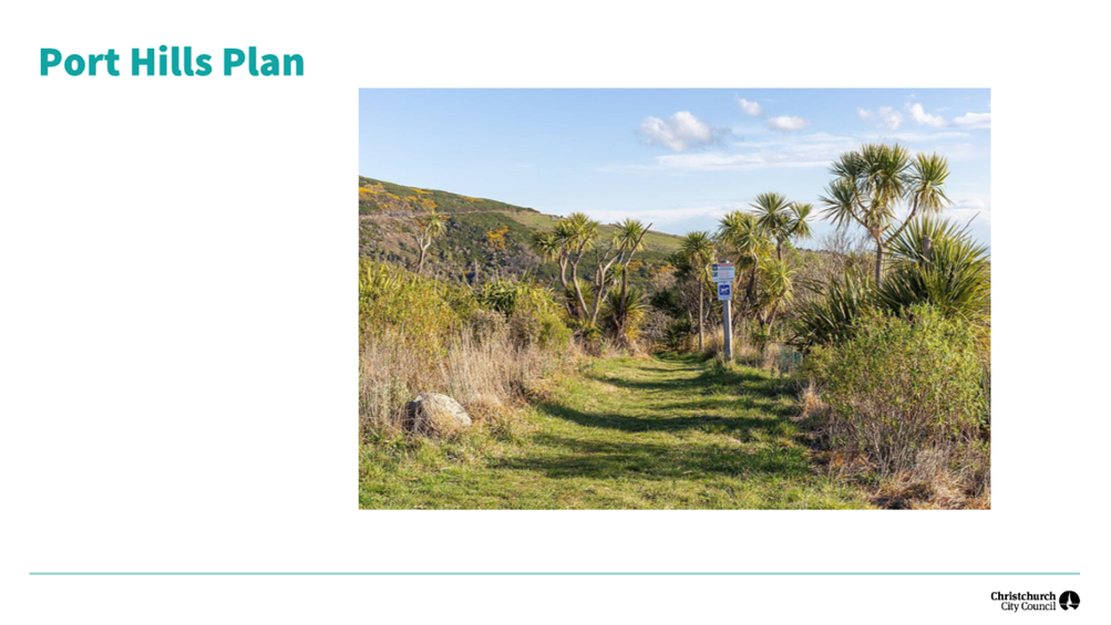 A trail with a sign in the middle of a grassy area

Description automatically generated