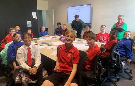 A group of Huritini Student Council members sitting at a table.