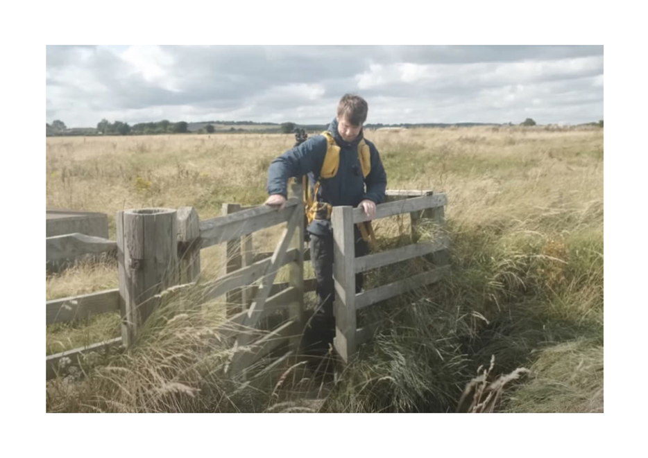 A person standing on a fence

Description automatically generated