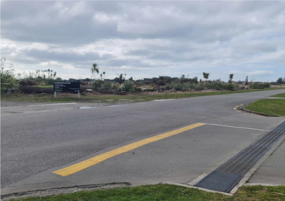 A road with a sign on it

Description automatically generated