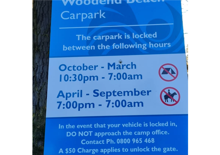 A blue sign on a tree

Description automatically generated
