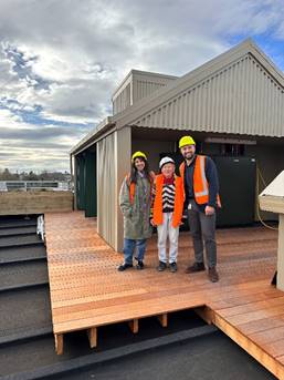 A group of people standing on a deck

Description automatically generated