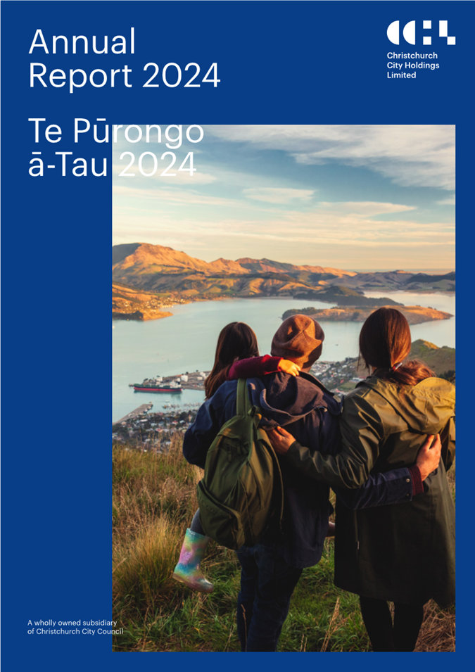 A group of people standing on a hill looking at a body of water

Description automatically generated