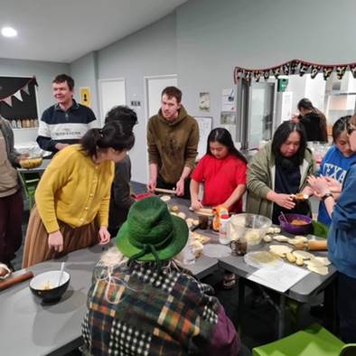 A group of people around a table

Description automatically generated