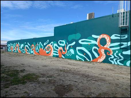 A wall with an octopus painting on it

Description automatically generated