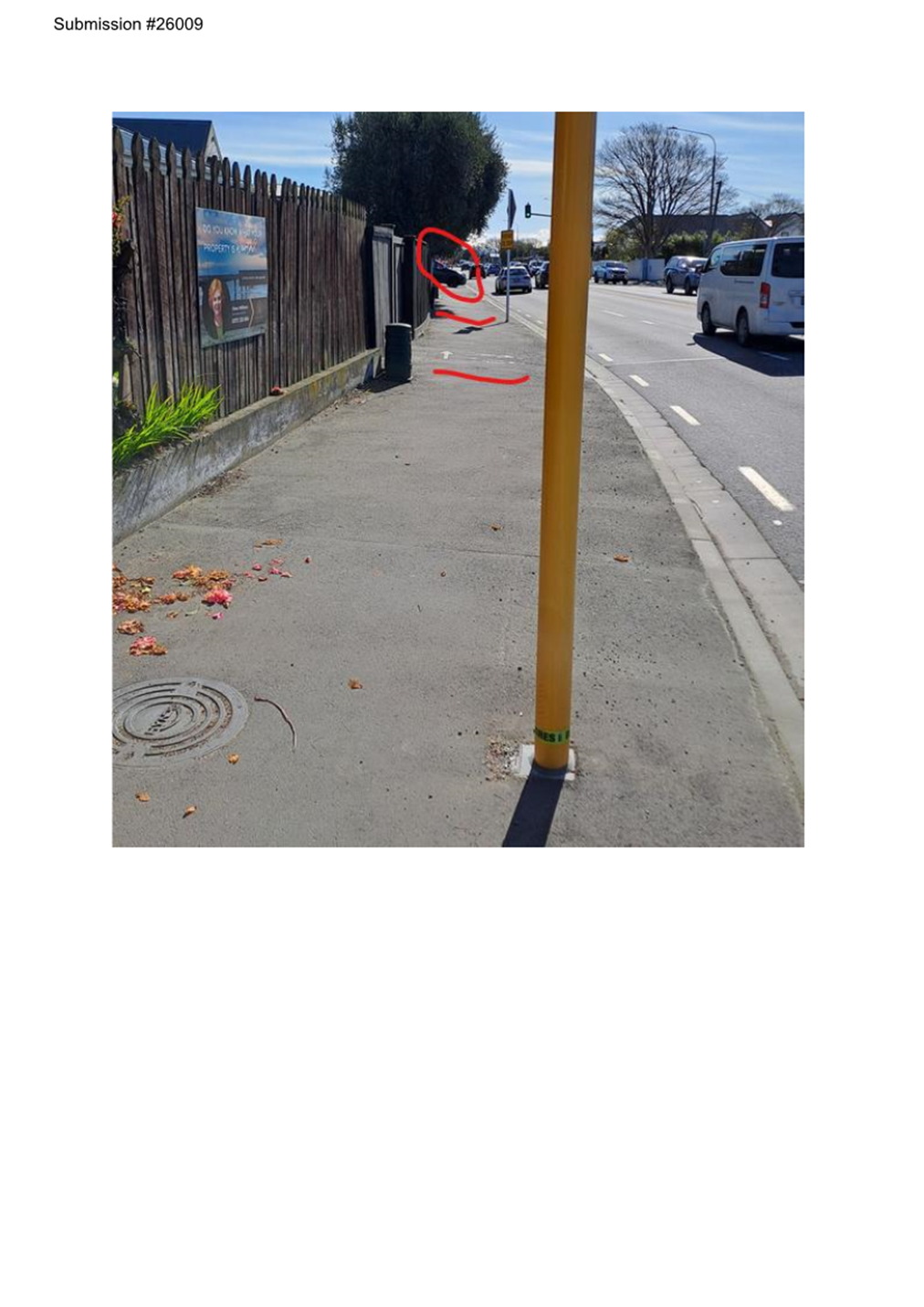 A yellow pole on a sidewalk

Description automatically generated