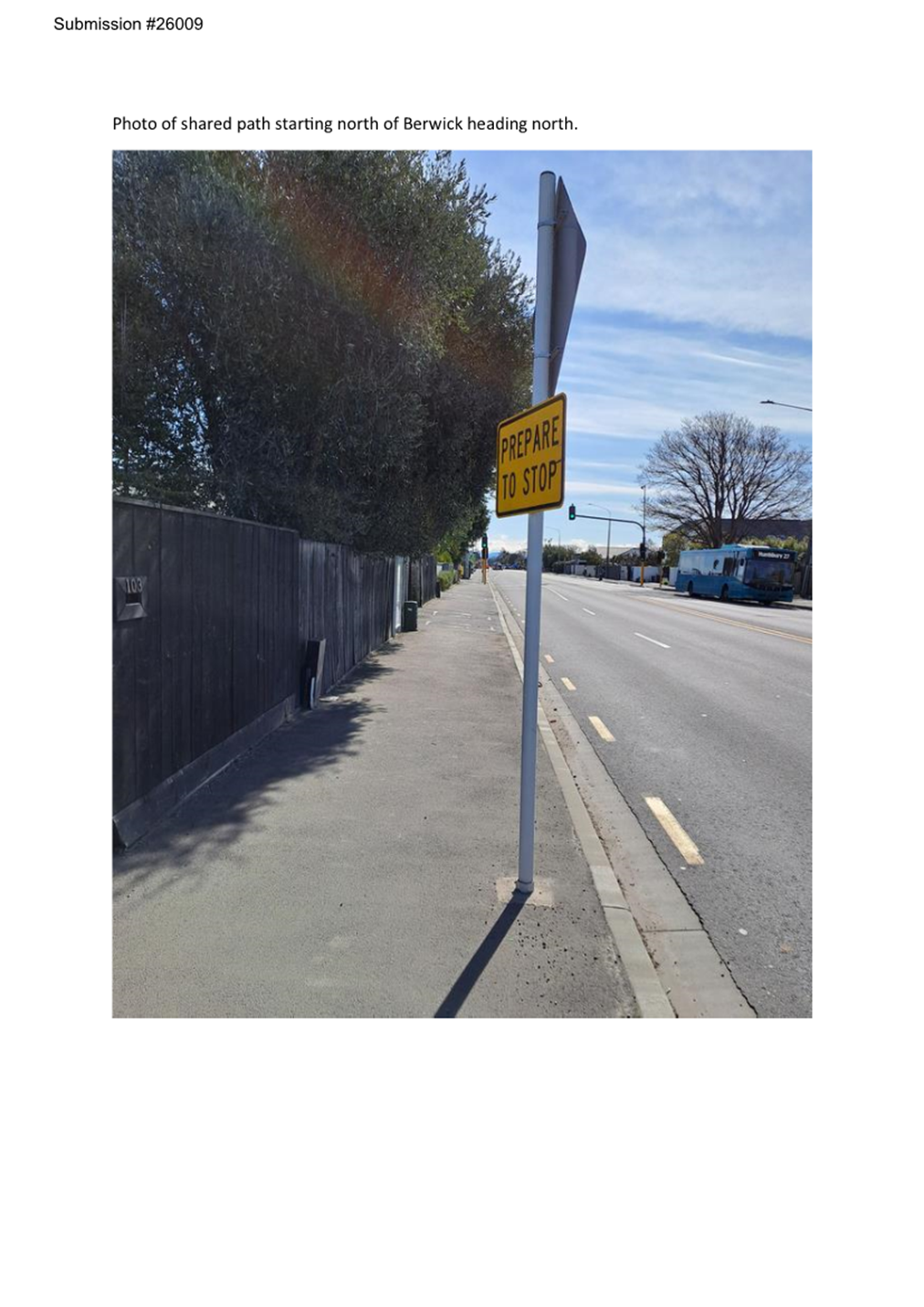 A yellow sign on a pole

Description automatically generated