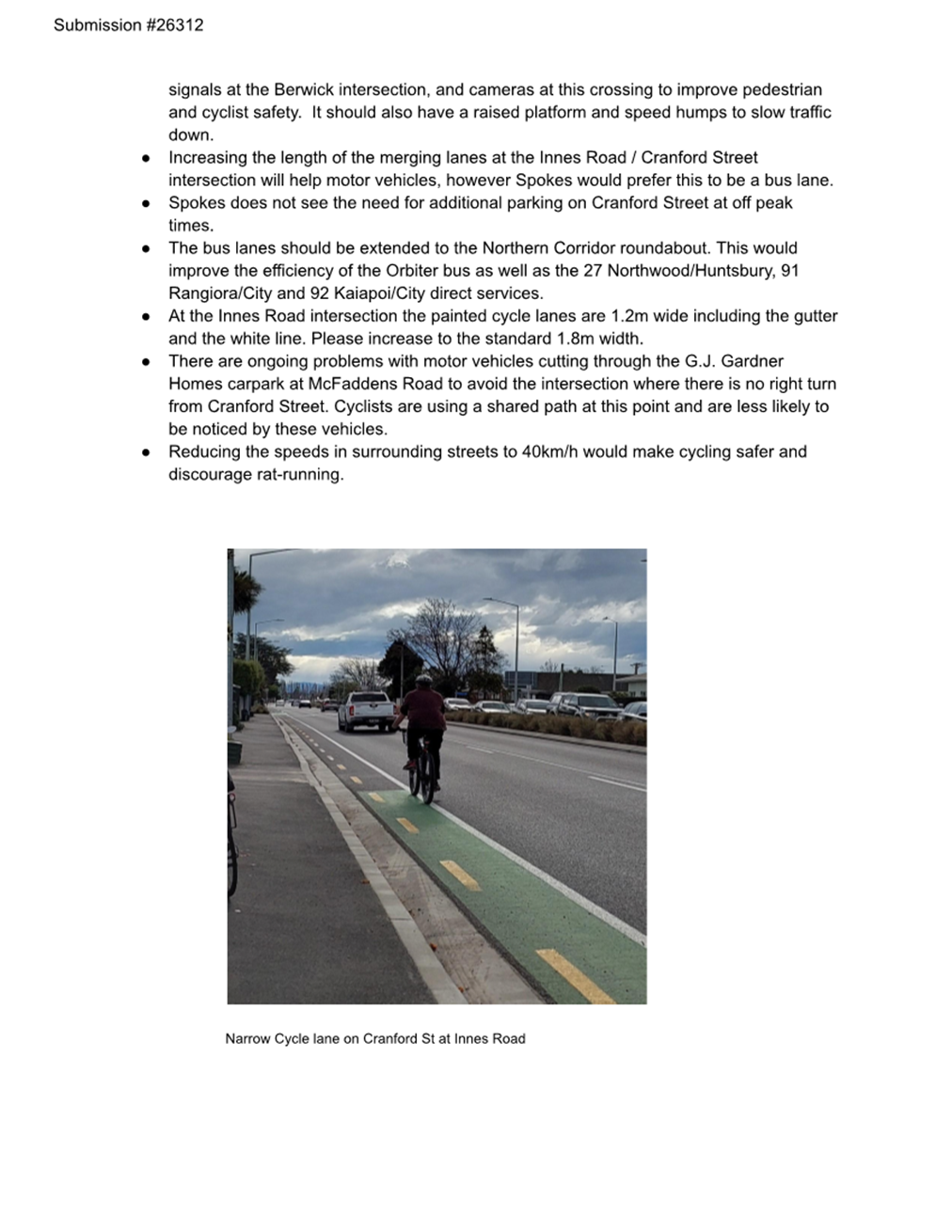 A bicycle lane with text and a person riding a bike

Description automatically generated