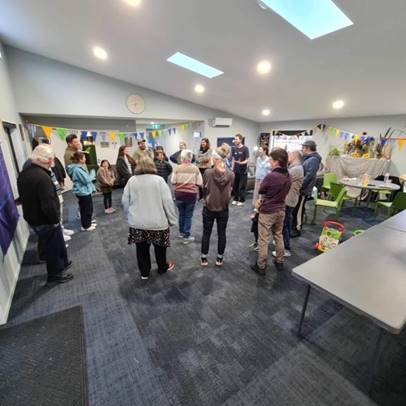 A group of people in a room

Description automatically generated