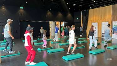 A group of people doing aerobics

Description automatically generated