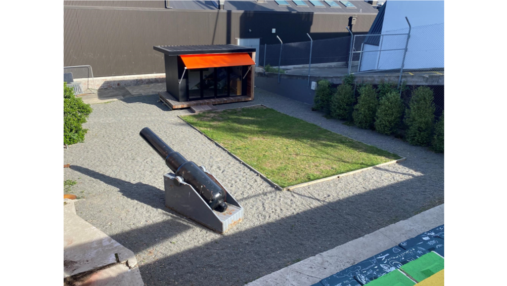 A cannon in a courtyard

Description automatically generated