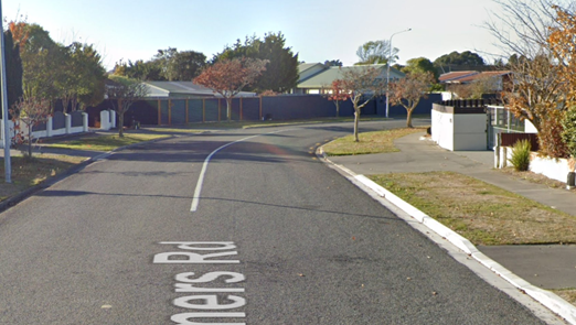 A street with a white line on the side

Description automatically generated