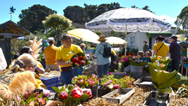A group of people in yellow shirts holding flowers

Description automatically generated