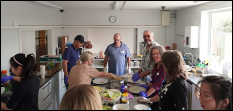 A group of people in a kitchen

AI-generated content may be incorrect.