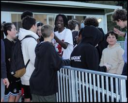 A group of people standing around a fence

AI-generated content may be incorrect.