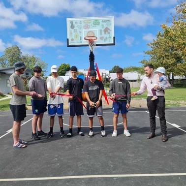 A group of people standing around a basketball hoop

AI-generated content may be incorrect.