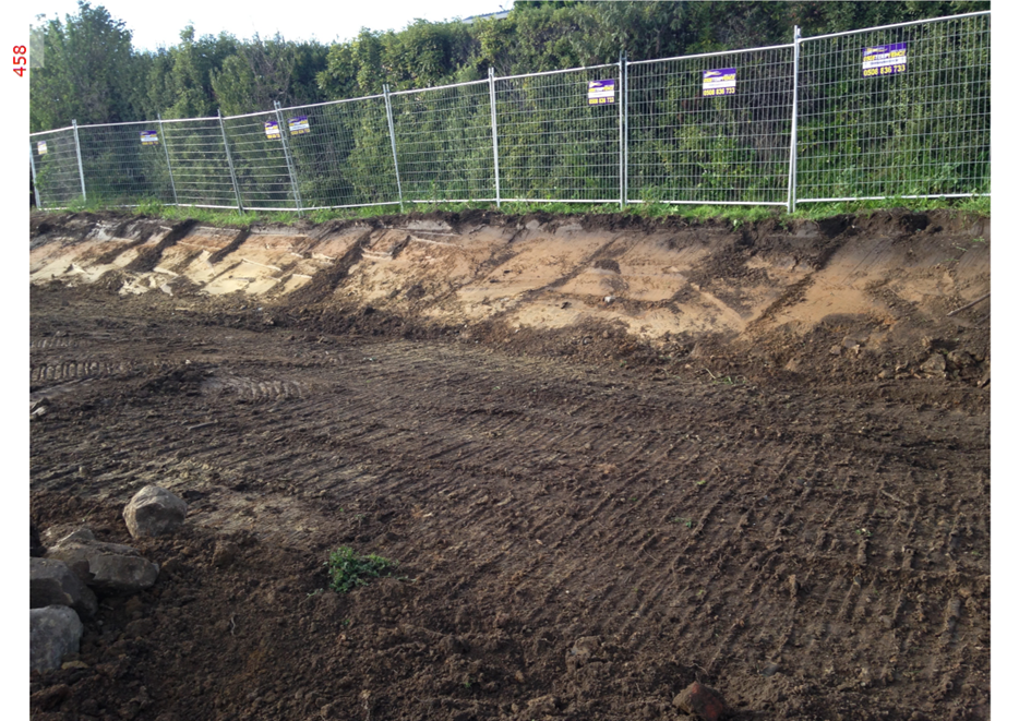 A dirt road with a fence and trees

AI-generated content may be incorrect.