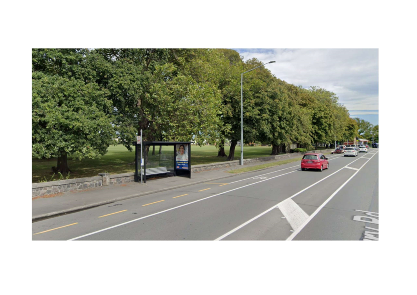 A road with trees and a bus stop

AI-generated content may be incorrect.