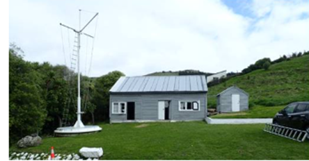 A grey building with a white roof

AI-generated content may be incorrect.